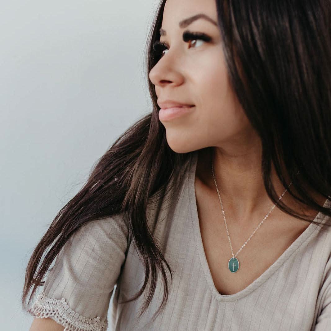 Model wearing Barberry & Lace's Oval Cross Necklace in Sterling Silver, perfect for daily wear with a meaningful faith symbol.