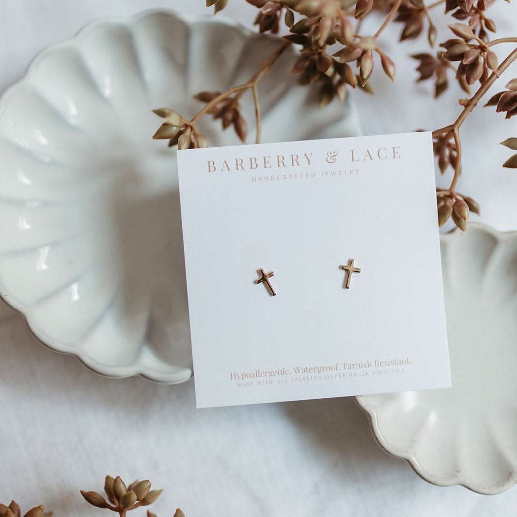 Hypoallergenic Cross Stud Earrings by Barberry & Lace Jewelry displayed on a white card with delicate gold cross design, ideal for sensitive ears.