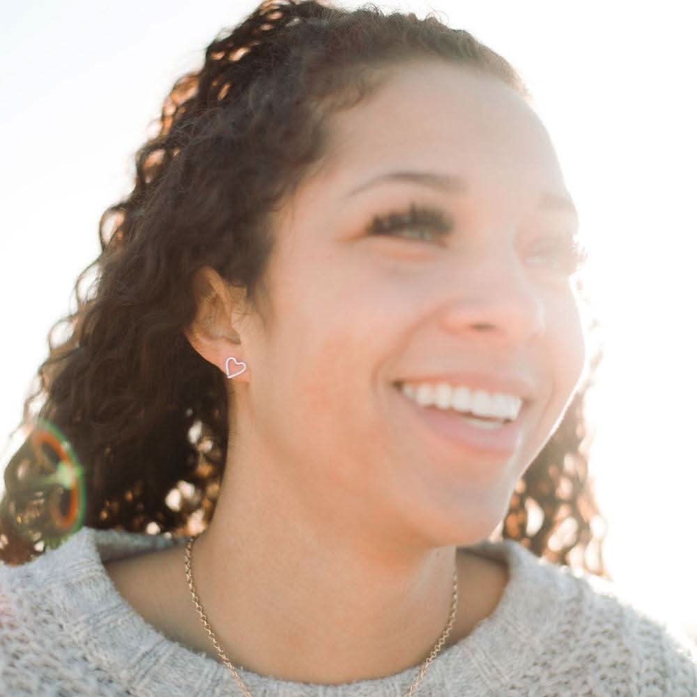 Model wearing Hammered Heart Stud Earrings by Barberry & Lace Jewelry, showcasing their minimalist heart design perfect for everyday wear.