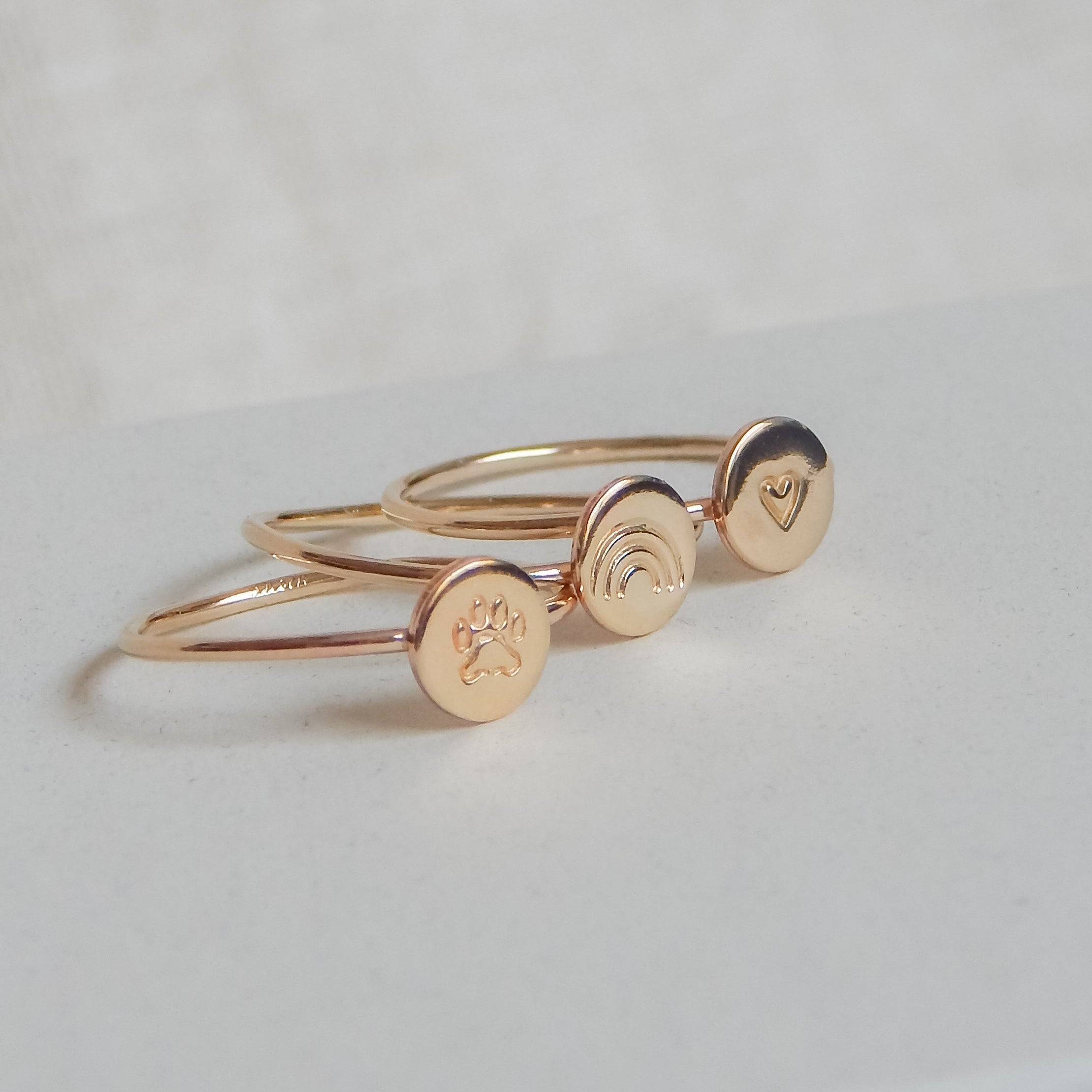 Personalized Dot Stacking Ring by Barberry & Lace Jewelry featuring hand-stamped designs like a paw print, rainbow, and heart in 14k gold fill.