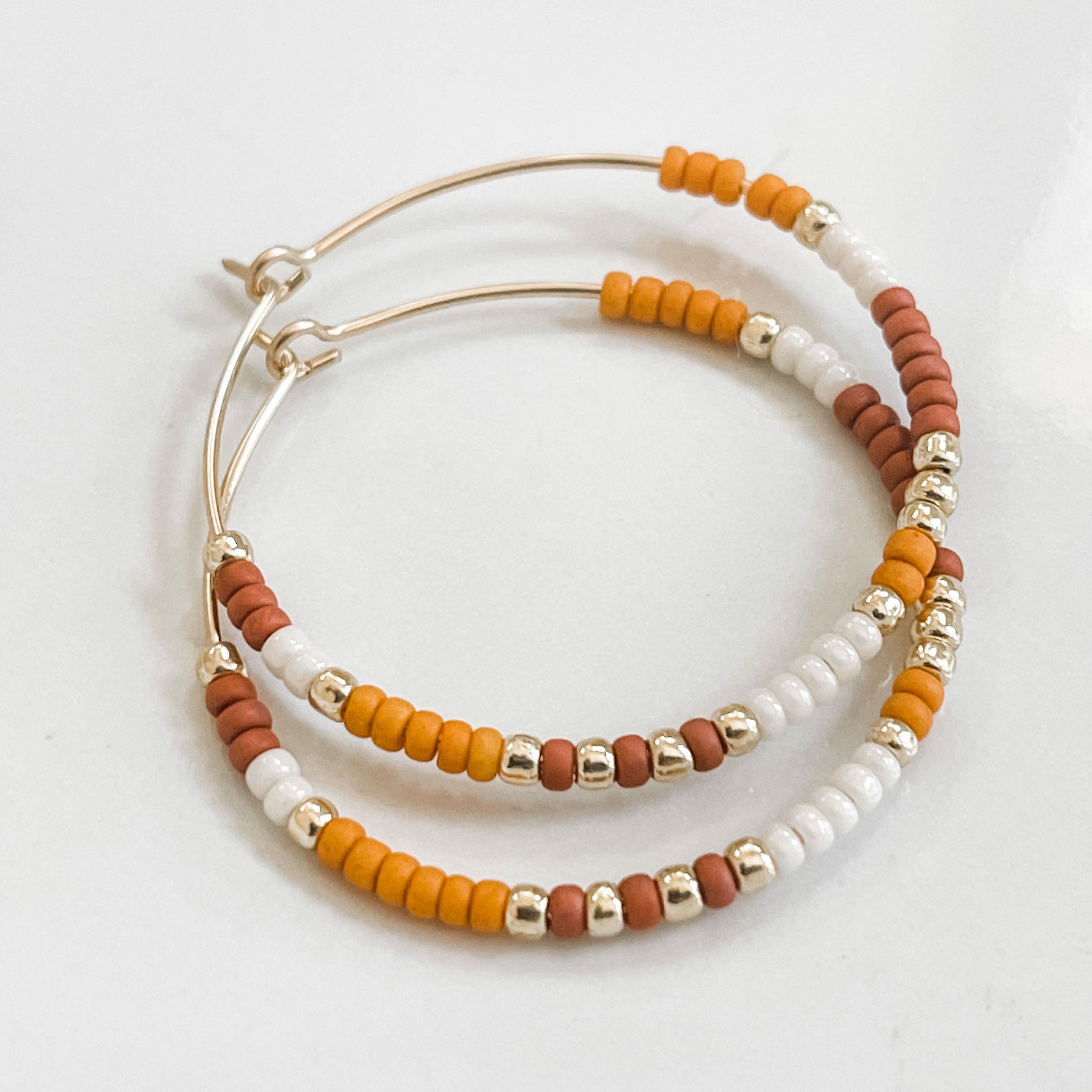Pumpkin Spice Fall Edition - Beaded Hoop Earrings with orange, white, and rust beads on gold hoops by Barberry & Lace Jewelry. Cozy autumn accessory.