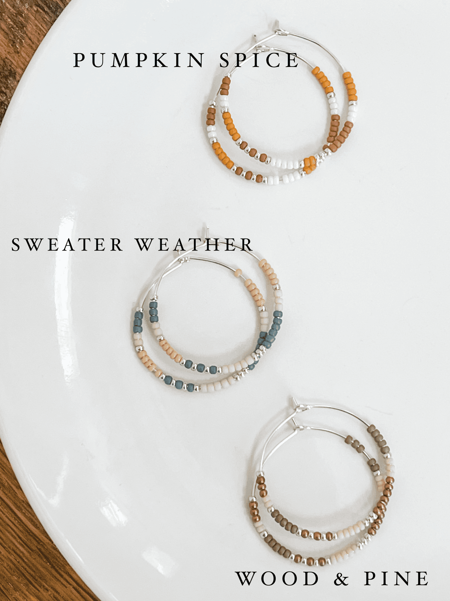 Flat lay of Pumpkin Spice, Sweater Weather, and Wood & Pine Fall Edition - Beaded Hoop Earrings on white plate. Seasonal earring collection.