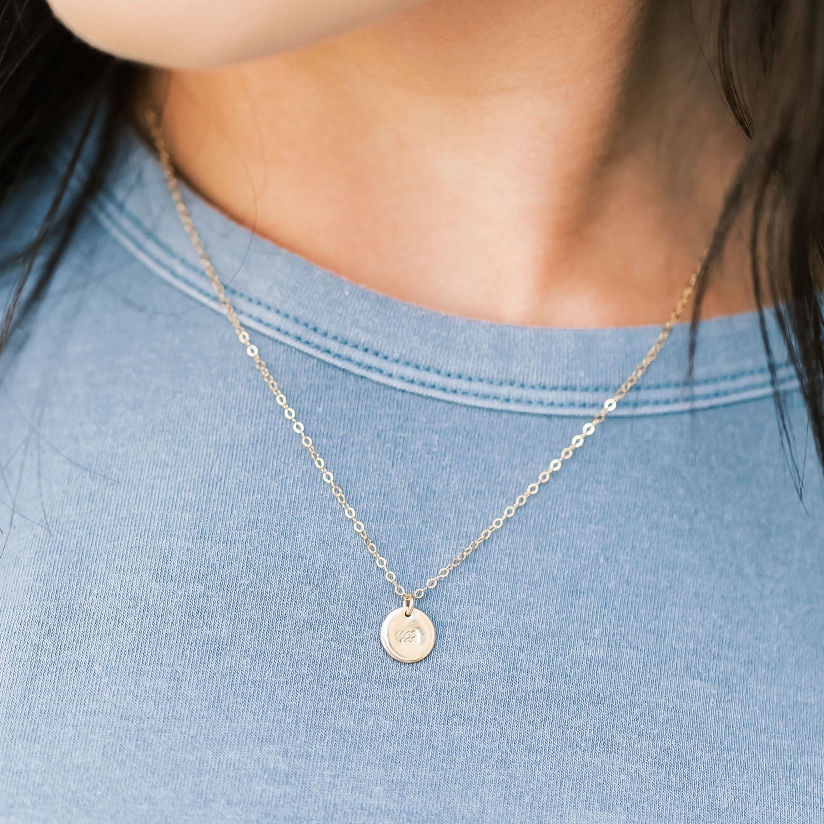 Model wearing Personalized Zodiac Disc Necklace with Aries charm in gold fill, ideal for everyday wear and celestial style.