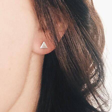 Sterling Silver Hypoallergenic Triangle Stud Earrings worn on ear, showcasing minimalist and waterproof style from Barberry & Lace Jewelry.