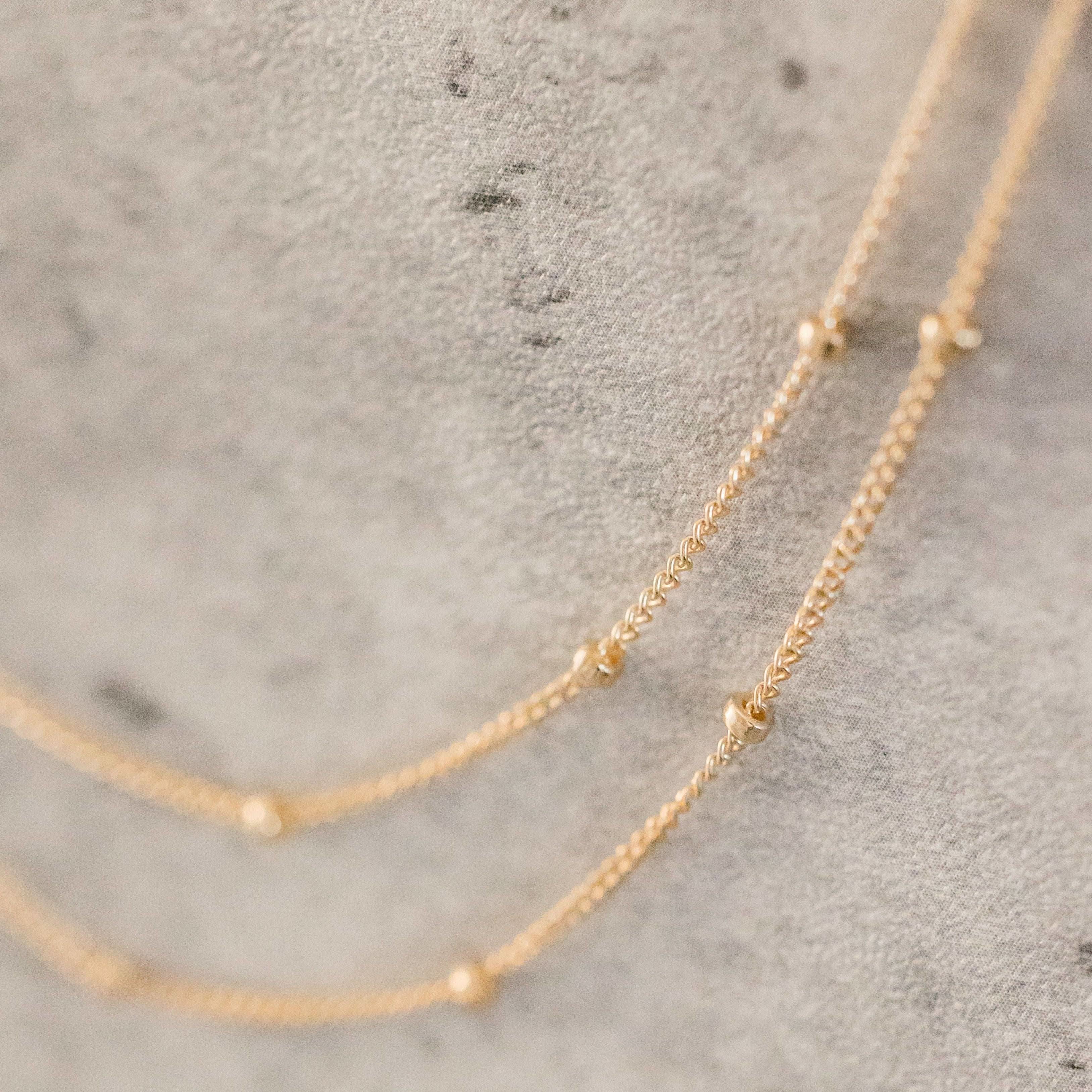 Close-up of Barberry & Lace Layering Satellite Chain Necklace in gold fill, featuring tiny bead stations for a refined, elegant finish.