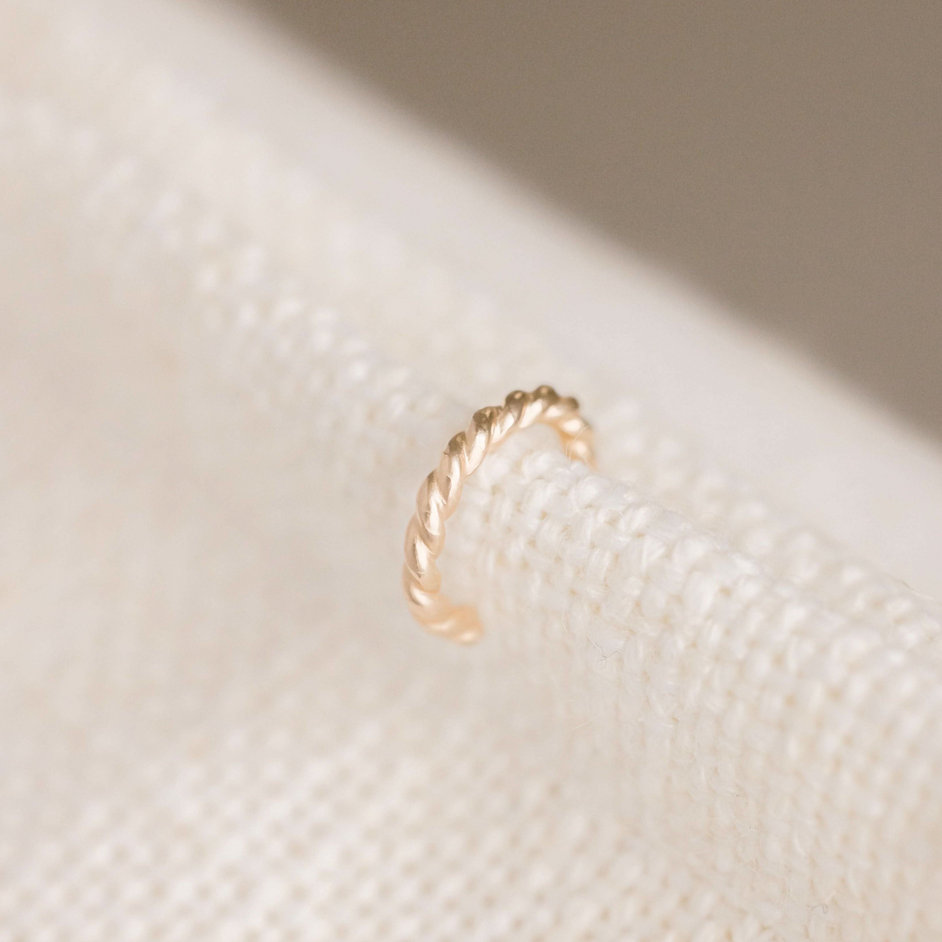 Twisted rope-style no-pierce ear cuff earring in 14k gold fill, ideal for minimalist and edgy jewelry looks.