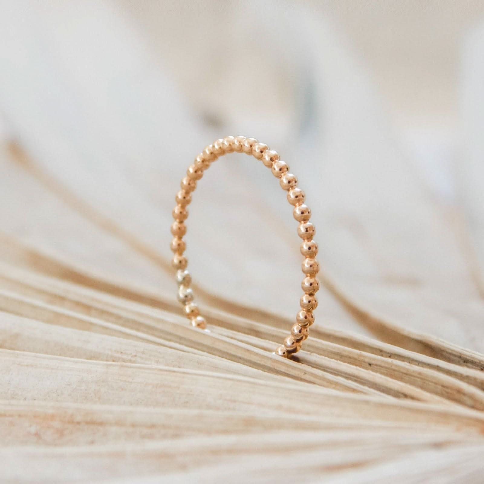Waterproof beaded stacking ring in 14k gold fill, displayed upright on a neutral background. Minimalist and hypoallergenic jewelry design.
