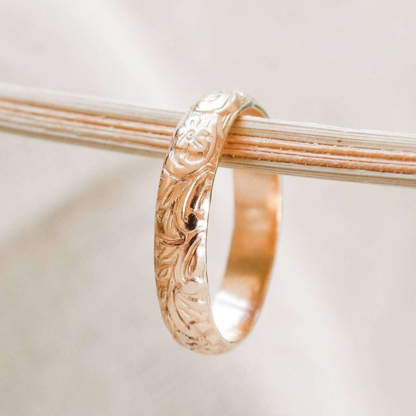 Close-up of Floral Band Ring in 14k Gold Fill with engraved floral motifs, a timeless piece from Barberry & Lace Jewelry.