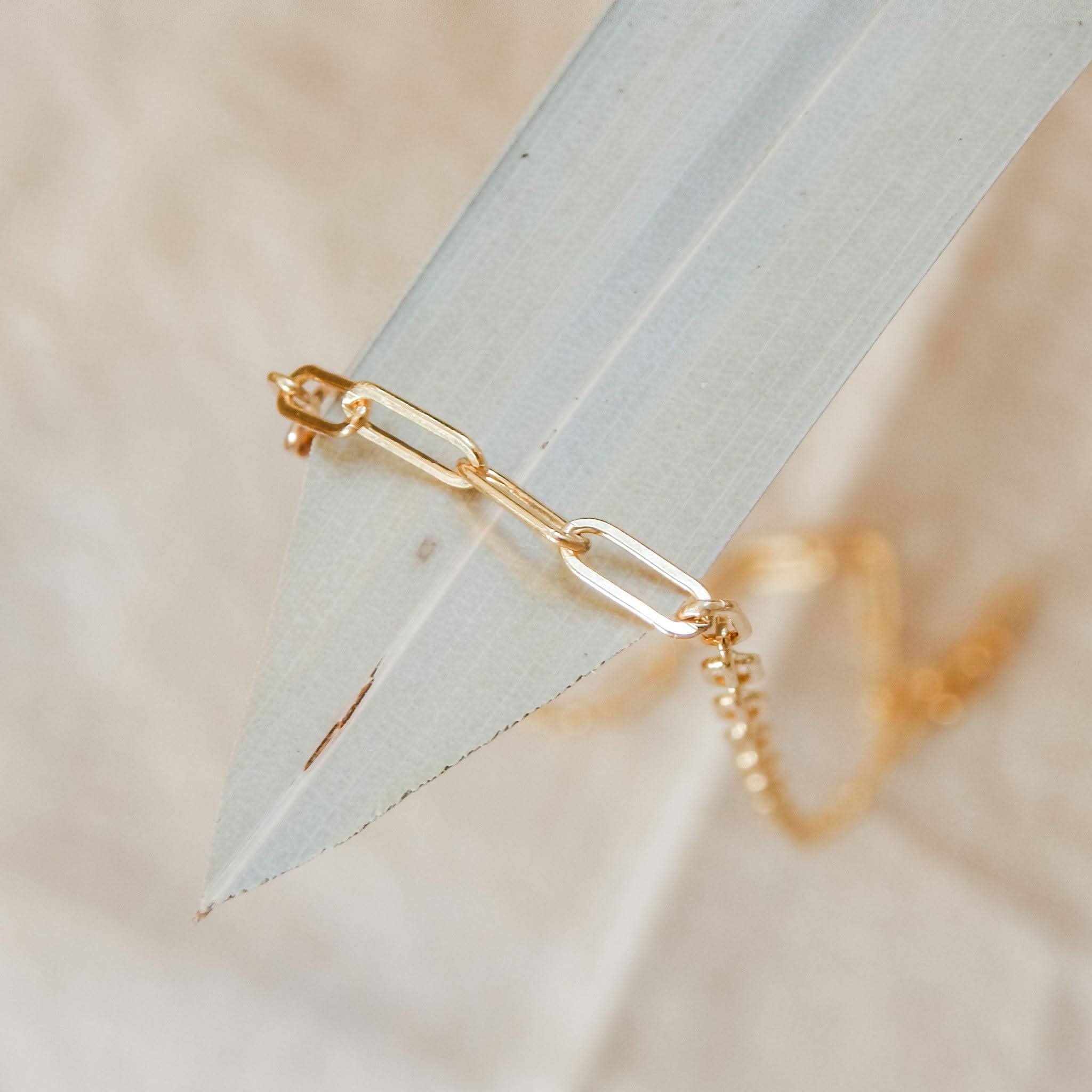 Close-up of Barberry & Lace Layering Paperclip Chain Necklace in 14k gold fill, showcasing minimalist elongated links on a neutral background.
