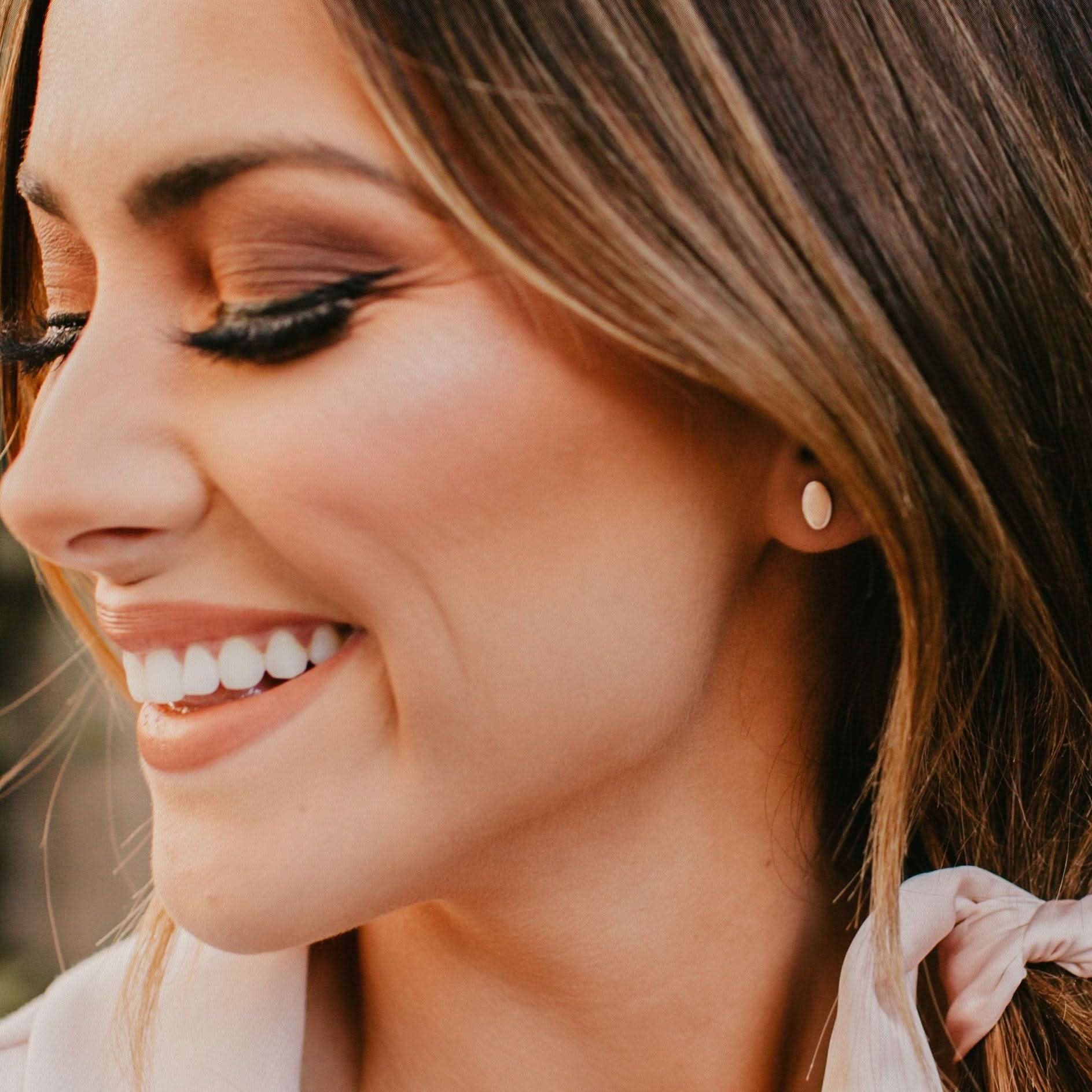 Smiling woman showcasing Barberry & Lace Hypoallergenic Oval Stud Earrings, perfect for timeless and elegant daily wear.