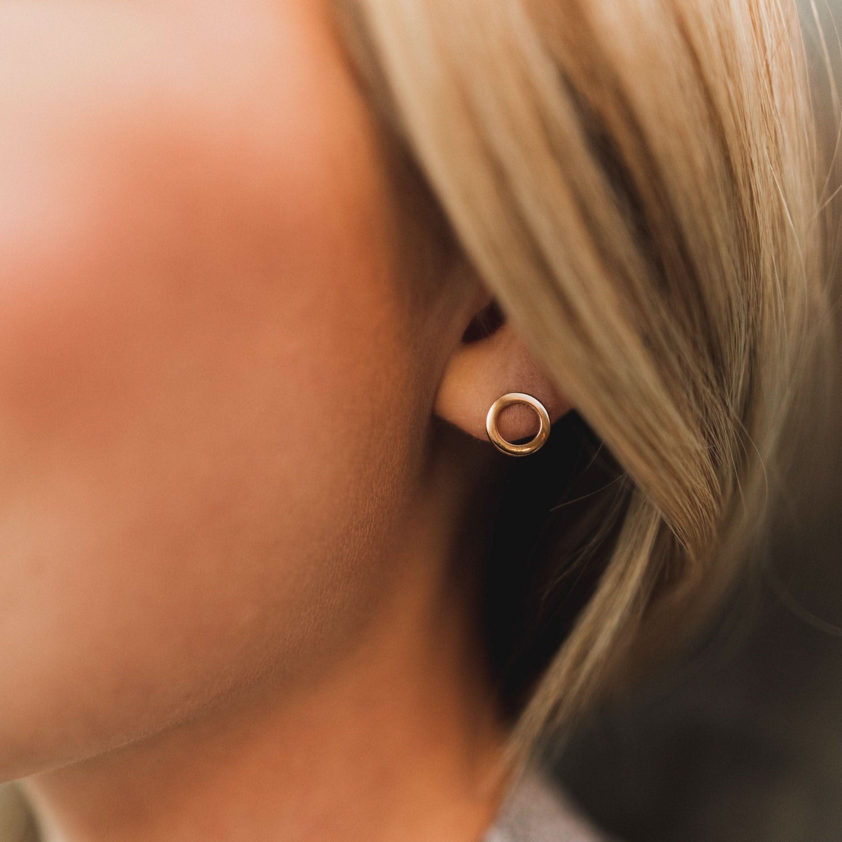 Barberry & Lace Open Circle Stud Earrings worn on ear, showcasing their sleek, hypoallergenic design perfect for everyday wear.
