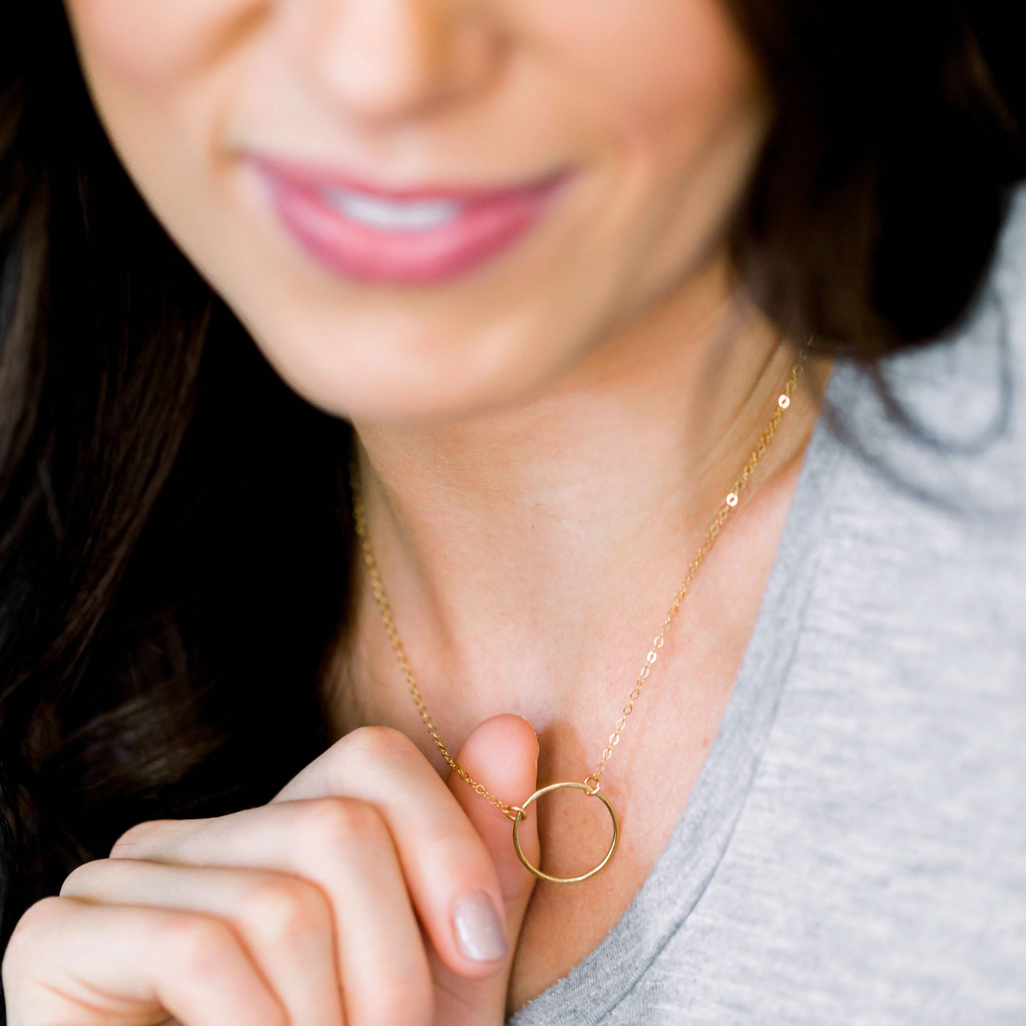 Woman wearing the Dainty Open Ring Necklace by Barberry & Lace. Elegant gold circle pendant on a delicate chain, perfect for everyday wear.
