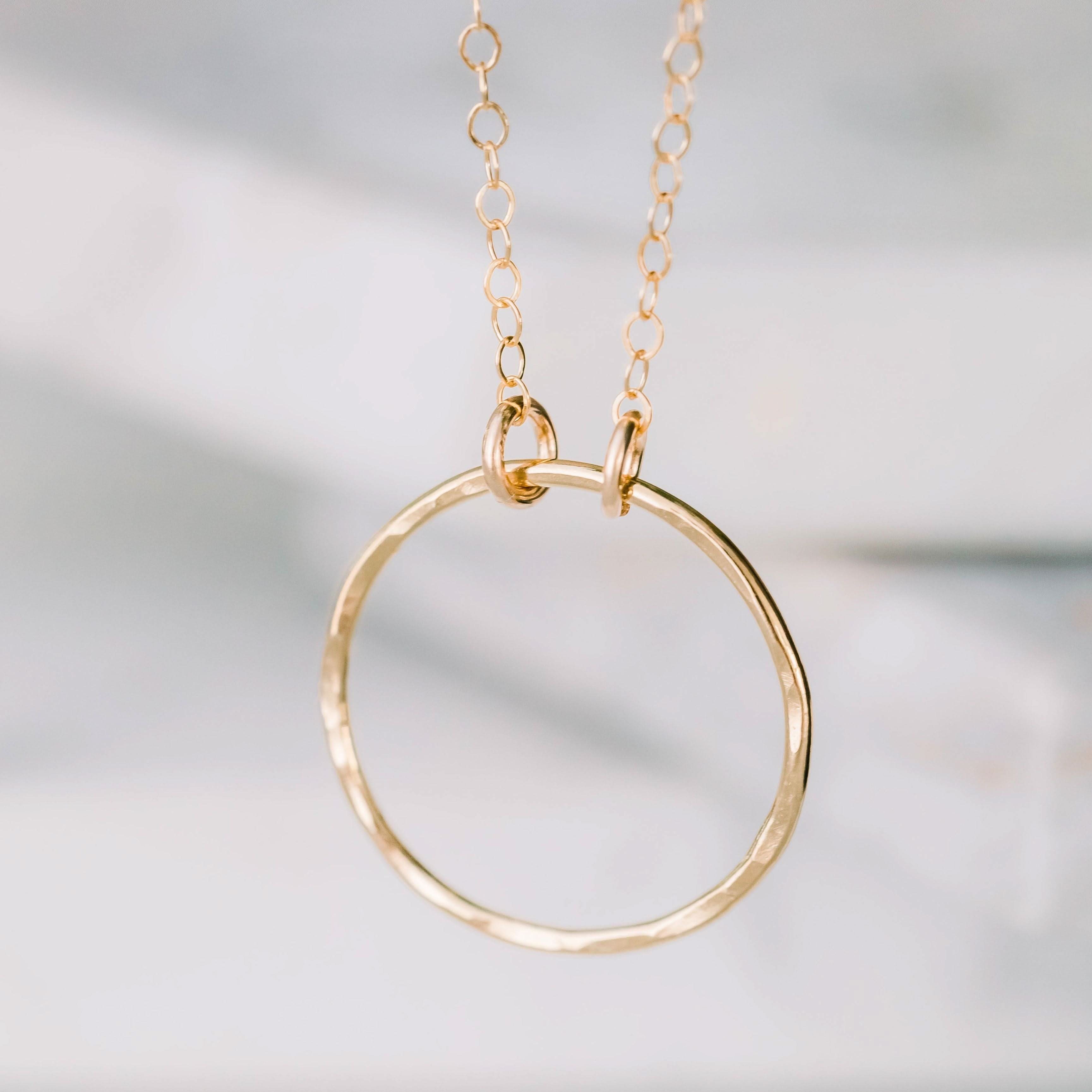 Close-up of Barberry & Lace's Dainty Open Ring Necklace in 14k gold fill. Features a hammered open circle pendant on a fine chain.