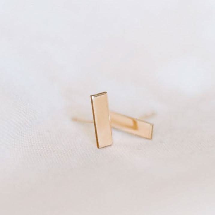 Hypoallergenic bar stud earrings in 14k gold fill with a sleek, minimalist design. Ideal for everyday wear and resistant to tarnish and water.