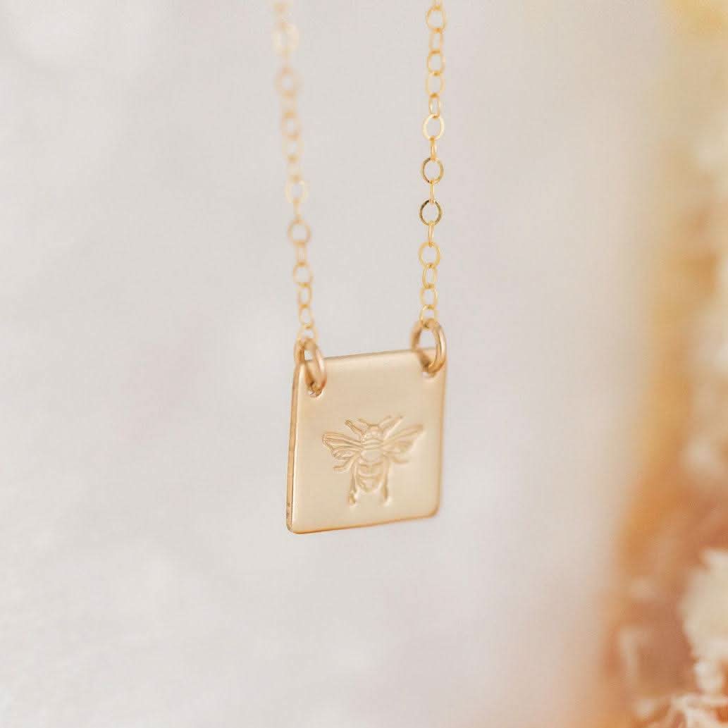 Honey Bee Necklace by Barberry & Lace Jewelry featuring a gold fill pendant engraved with a bee on a delicate chain. Ideal for nature lovers.
