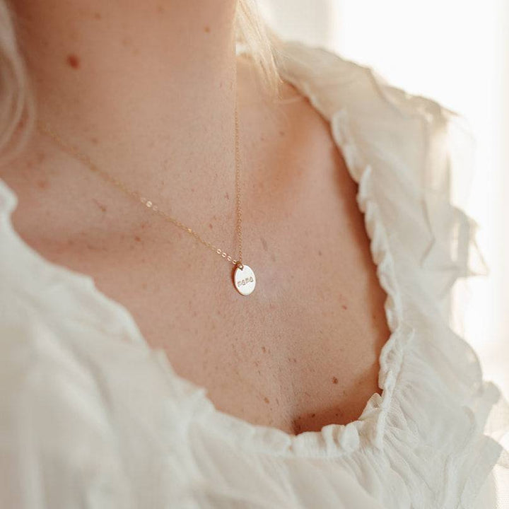 Mama Disc Necklace worn on a woman, showcasing the elegant gold pendant and fine chain, ideal for everyday wear and gifting.