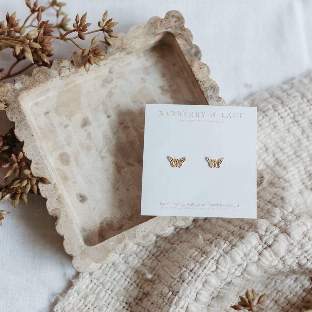 Butterfly Stud Earrings on Barberry & Lace Jewelry card, highlighting hypoallergenic and waterproof features for sensitive ears.