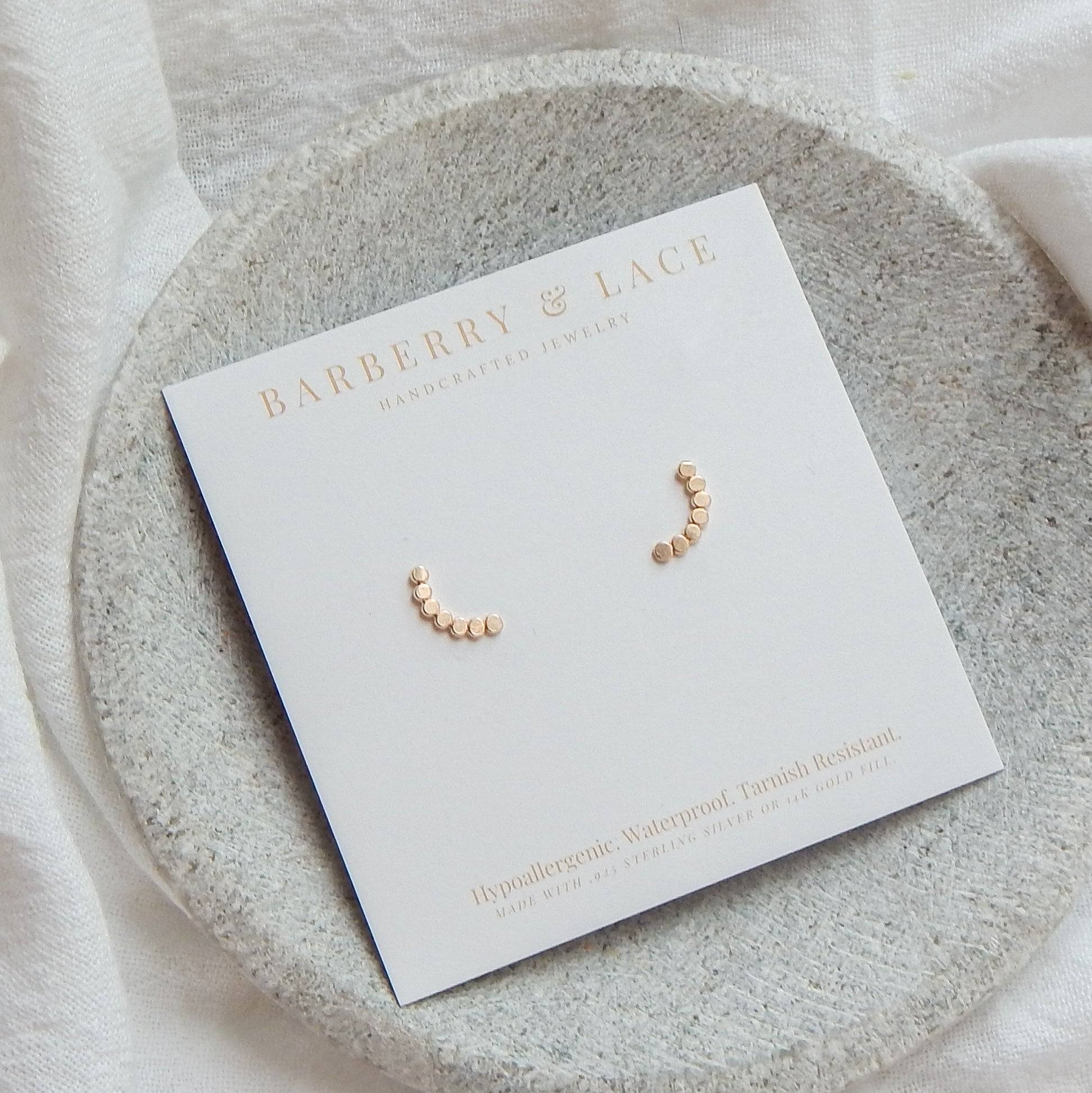 Dotted Arc Stud Earrings by Barberry & Lace Jewelry displayed on branded card. Handmade 14k gold fill, hypoallergenic and waterproof design.