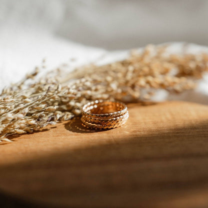 Baguette Twisted Stacking Rings by Barberry & Lace Jewelry arranged on a wooden surface with dried florals, ideal for minimalist stacking.