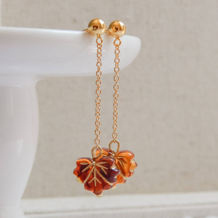 Falling Leaf Earrings by Barberry & Lace Jewelry feature amber-toned leaf charms on 14k gold fill chains. Elegant, hypoallergenic, and autumn-inspired.