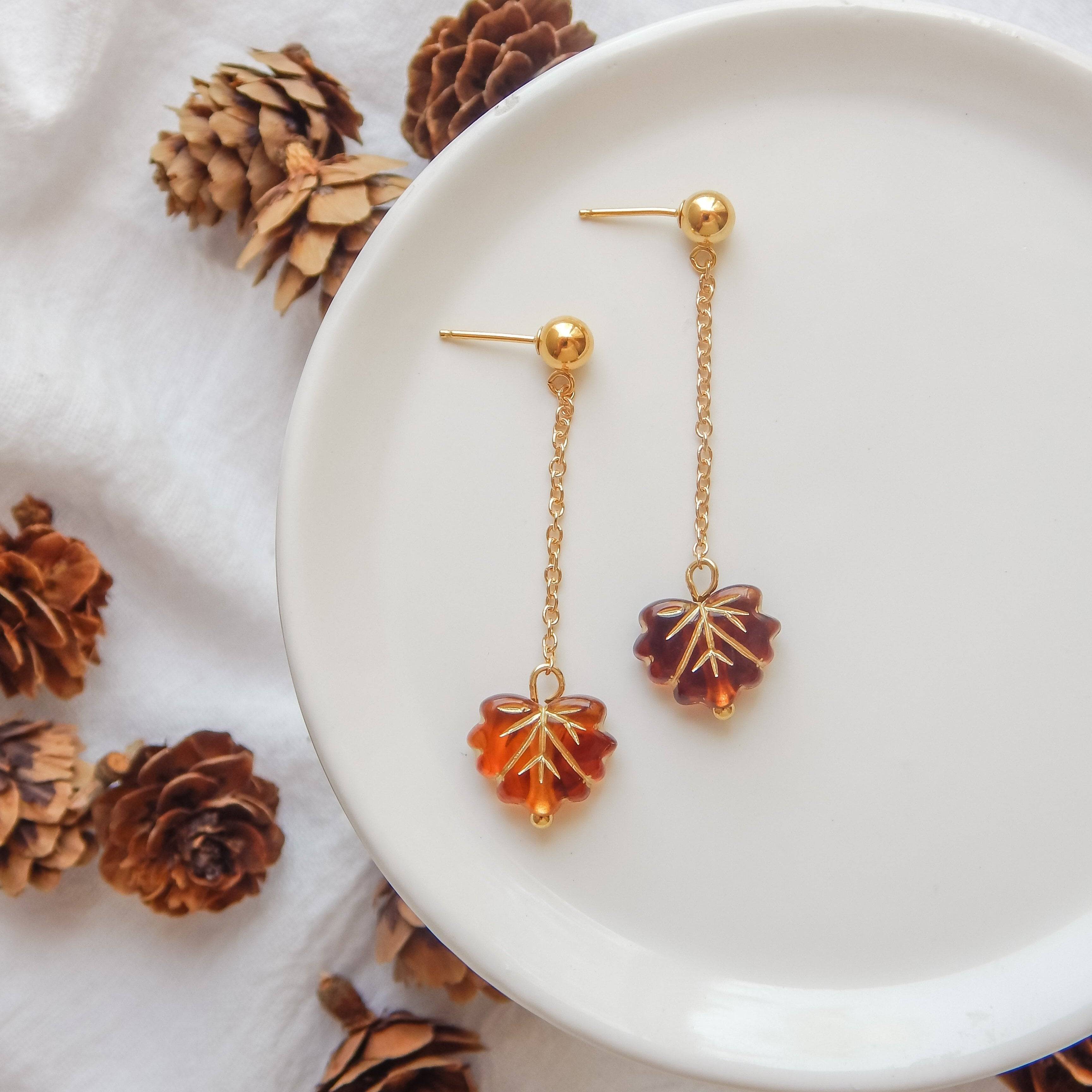 Falling Leaf Earrings by Barberry & Lace Jewelry feature gold fill chains with amber-toned leaf charms. Elegant, hypoallergenic, and autumn-inspired design.