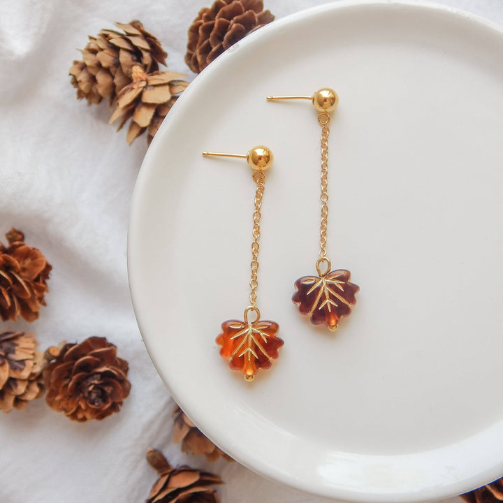 Falling Leaf Earrings by Barberry & Lace Jewelry feature gold fill chains with amber-toned leaf charms. Elegant, hypoallergenic, and autumn-inspired design.