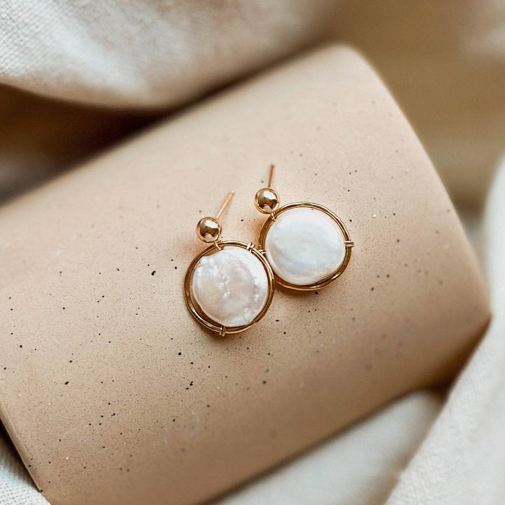 Fresh Water Pearl Halo Earrings by Barberry & Lace Jewelry featuring AA-grade coin pearls in 14k gold fill with a hammered finish on a neutral display.