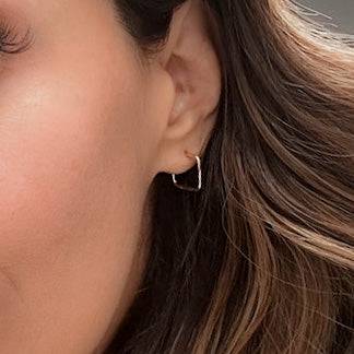 Square Hoop Stud Earrings worn on ear, showcasing their minimalist 14k gold fill design. Perfect for a modern, everyday jewelry look.