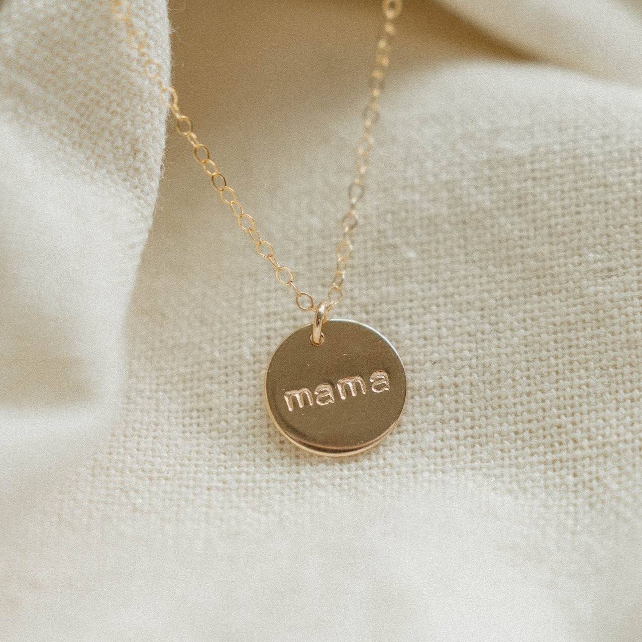 Close-up of the Mama Disc Necklace in 14k gold fill by Barberry & Lace Jewelry, featuring a delicate chain and engraved 'mama' pendant.