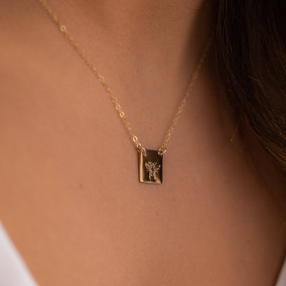 Honey Bee Necklace in 14k gold fill shown on model, highlighting the detailed bee engraving and dainty chain. Perfect everyday jewelry piece.