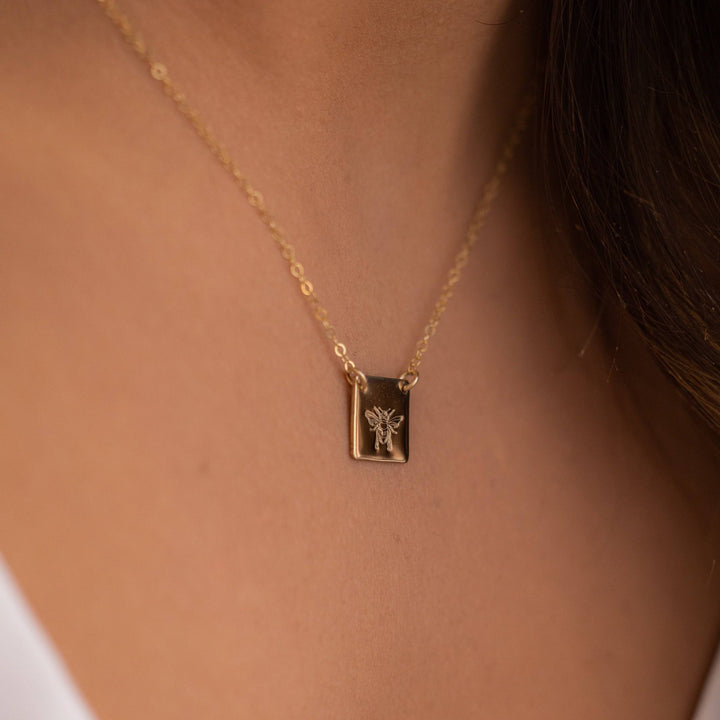 Honey Bee Necklace in 14k gold fill shown on model, highlighting the detailed bee engraving and dainty chain. Perfect everyday jewelry piece.