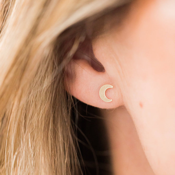 Crescent Moon Stud Earrings | Barberry & Lace Jewelry shown worn on ear, minimalist 14k gold fill design ideal for everyday celestial style.