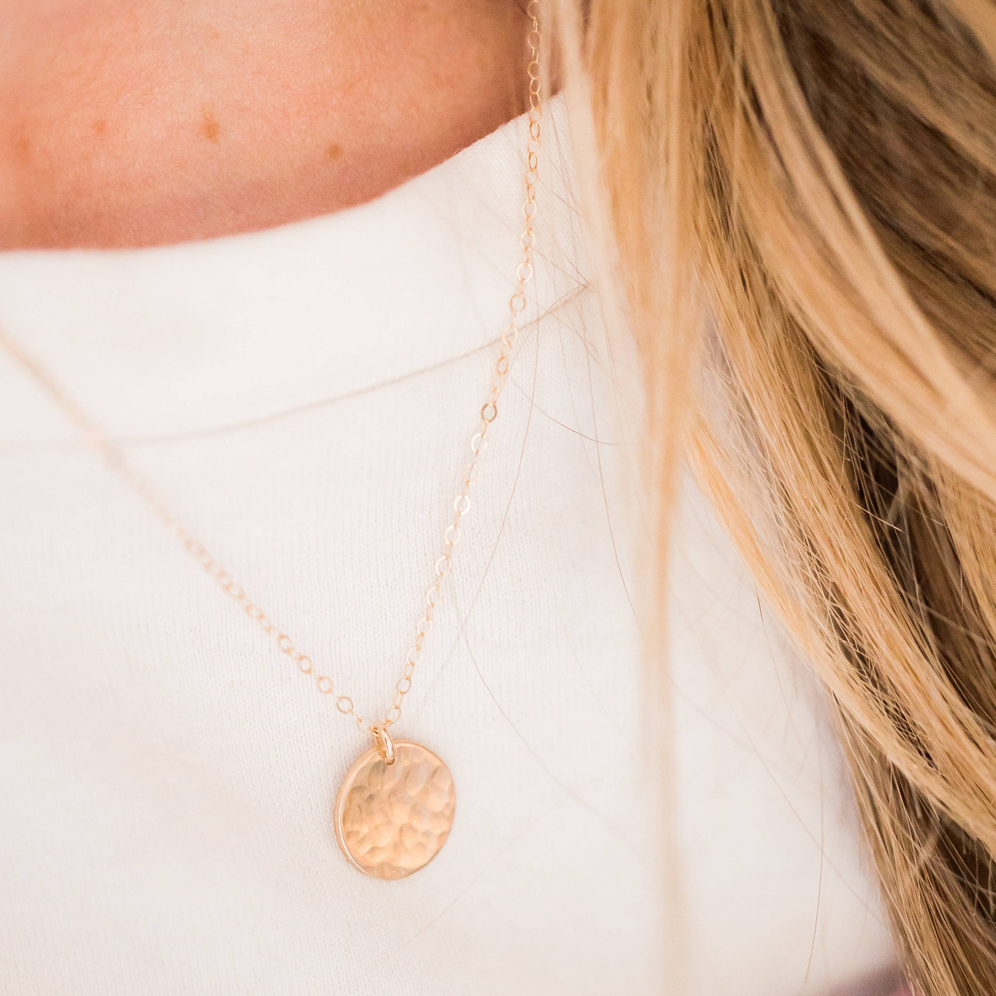 Layering Hammered Disc Necklace in 14k Gold Fill worn on a woman, showcasing its minimalist shimmer and delicate chain for everyday elegance.