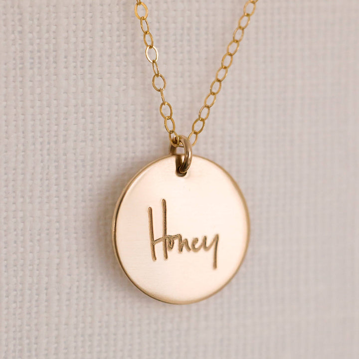 Handwritten Disc Necklace by Barberry & Lace Jewelry featuring 'Honey' engraving on a gold fill disc, hypoallergenic and waterproof, perfect for gifting.