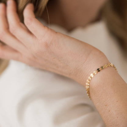 Woman wearing the Barberry & Lace Disc Chain Bracelet in gold, showcasing its elegant and minimalist style for everyday jewelry wear.