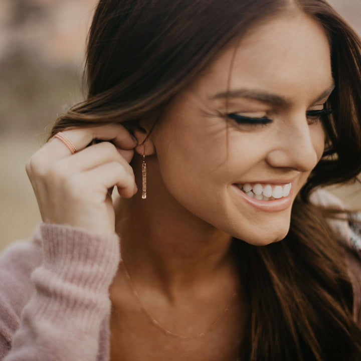 Woman wearing Hammered Bar Dangle Earrings by Barberry & Lace Jewelry, showcasing their elegant, lightweight style perfect for daily outfits.