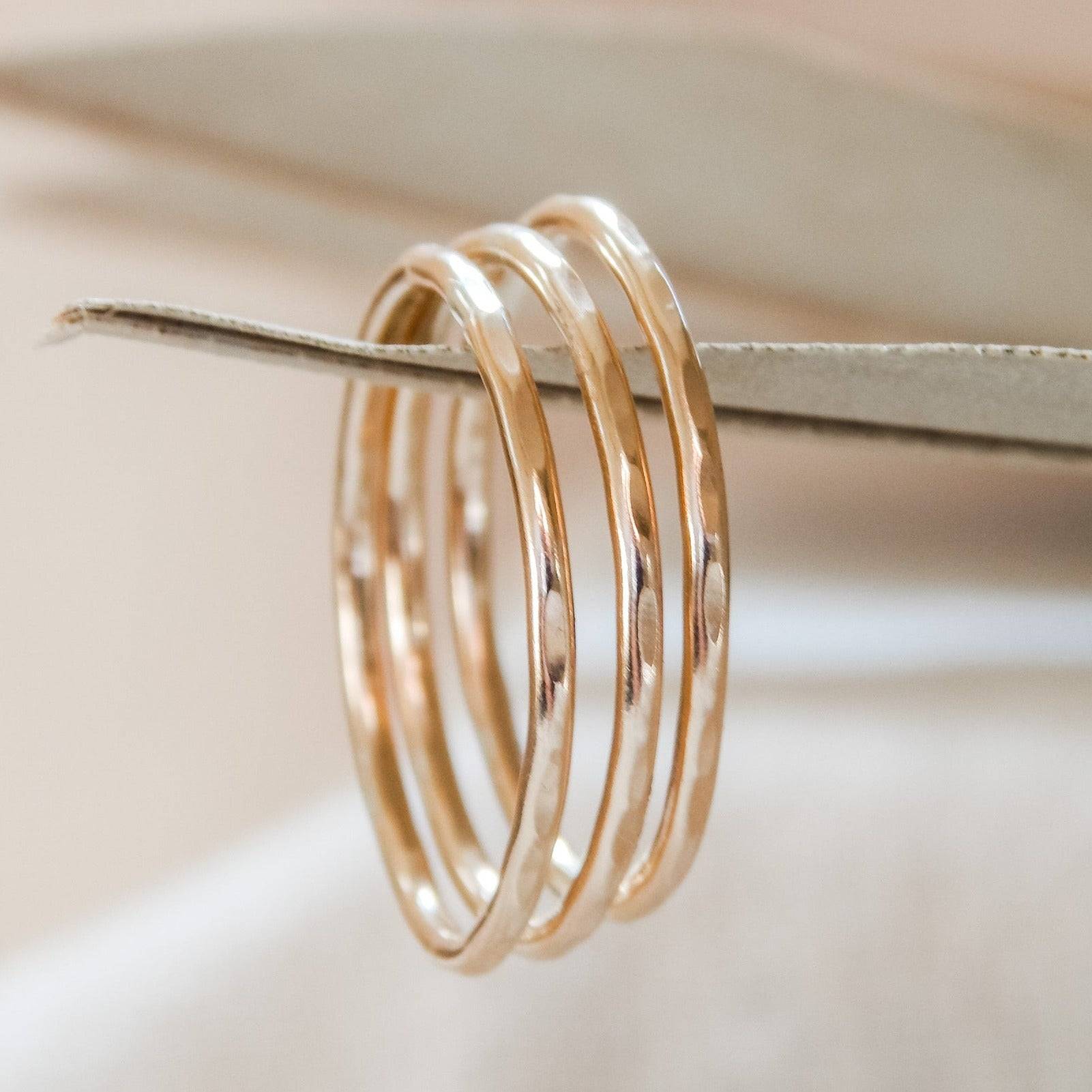 Thin Hammered Band Stacking Ring in 14k gold fill displayed on a neutral background, showcasing its delicate texture and minimalist design.