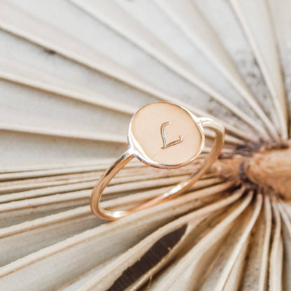 Personalized Circle Stacking Ring by Barberry & Lace Jewelry featuring an engraved initial 'L' on a 14k gold fill band, perfect for gifting.