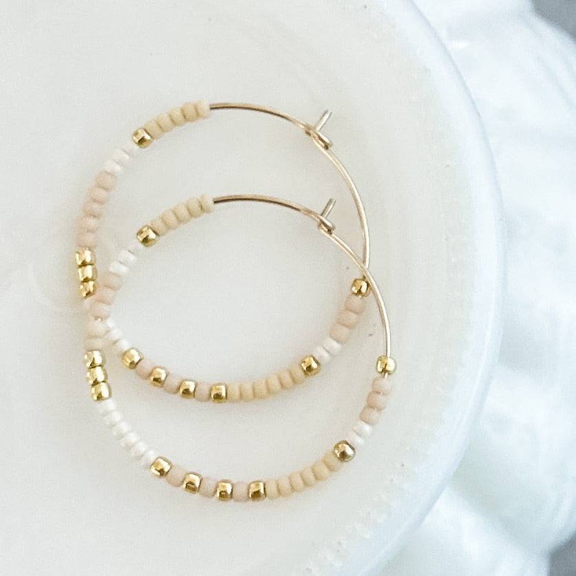 Holiday Edition - Beaded Hoop Earrings in Sugar Cookie with soft cream and gold beads. Subtle and elegant for everyday or festive looks.