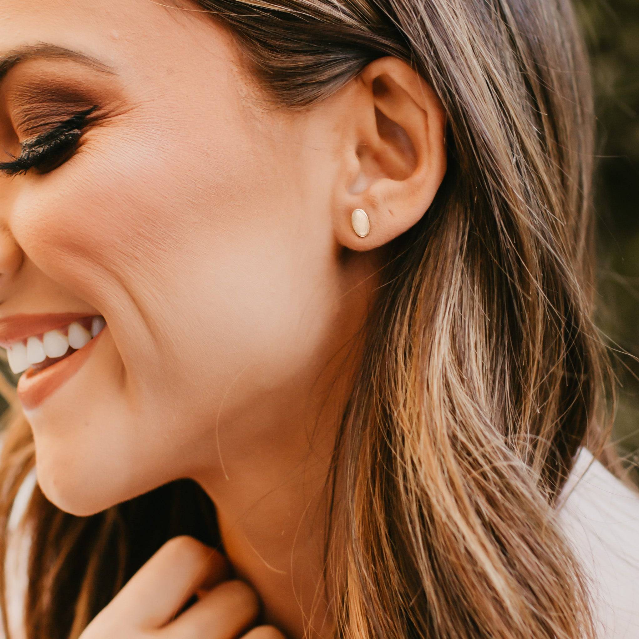 Woman wearing Hypoallergenic Oval Stud Earrings by Barberry & Lace Jewelry in 14k Gold Fill, ideal for everyday minimal style.