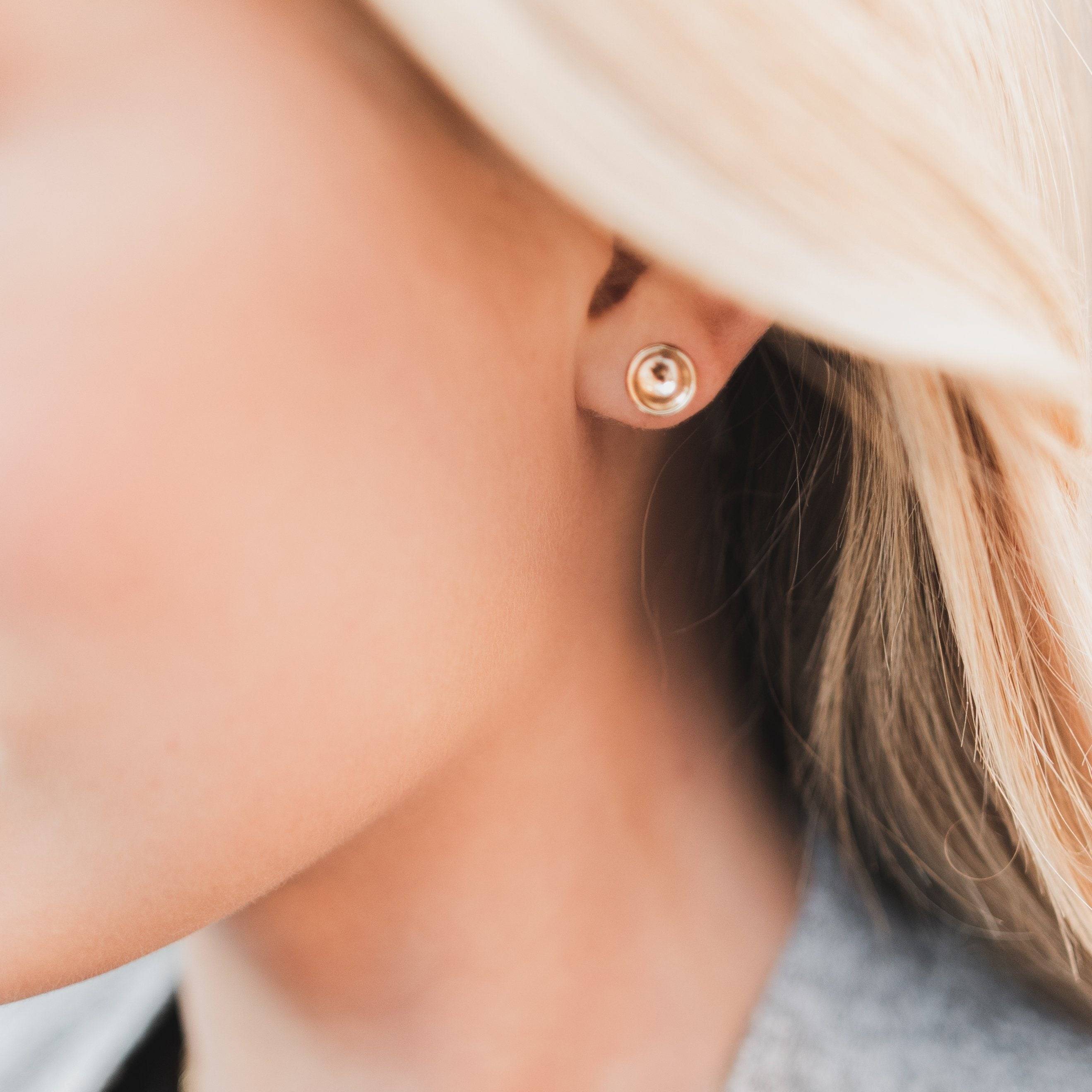 Concave Disc Stud Earrings in 14k Gold Fill worn on ear, showcasing minimalist and modern design by Barberry & Lace Jewelry.