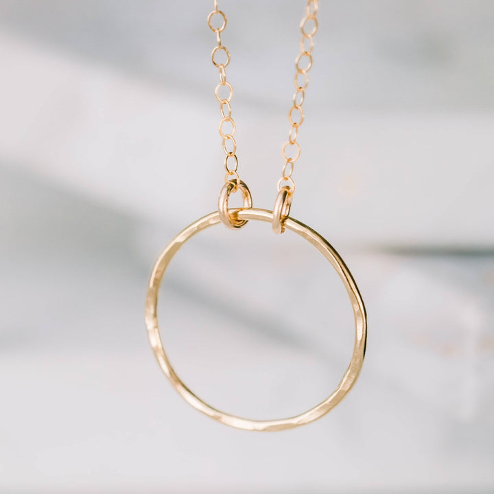 Close-up of Barberry & Lace's Dainty Open Ring Necklace in 14k gold fill. Features a hammered open circle pendant on a fine chain.