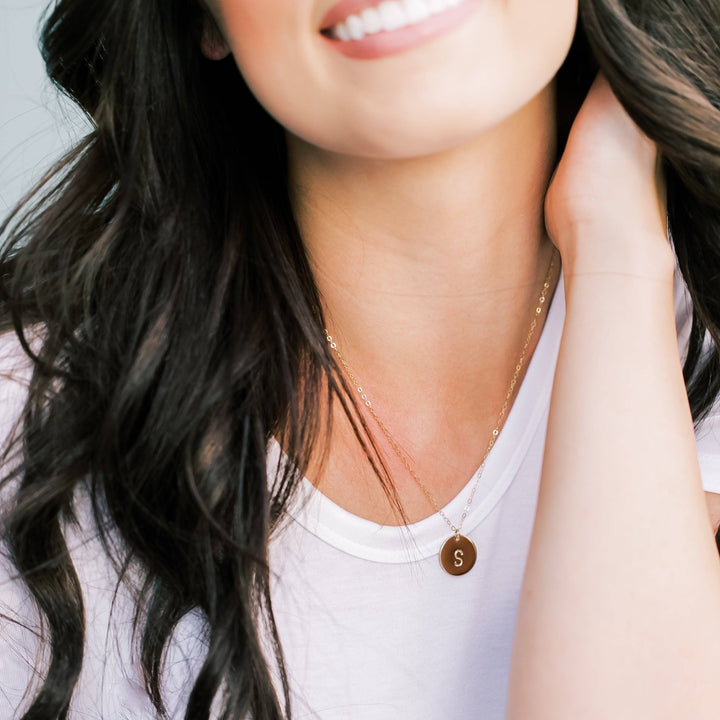 5/8" Personalized Disc Necklace by Barberry & Lace Jewelry featuring a gold filled disc engraved with an initial, worn by a smiling woman.