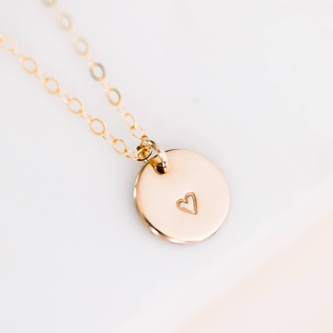 Hand stamped heart disc necklace in 14k gold fill with delicate chain, from Barberry & Lace Jewelry. Minimalist charm for everyday wear.