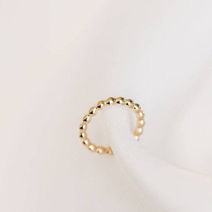 Beaded texture no-pierce ear cuff earring in 14k gold fill, offering a chic and hypoallergenic jewelry option.
