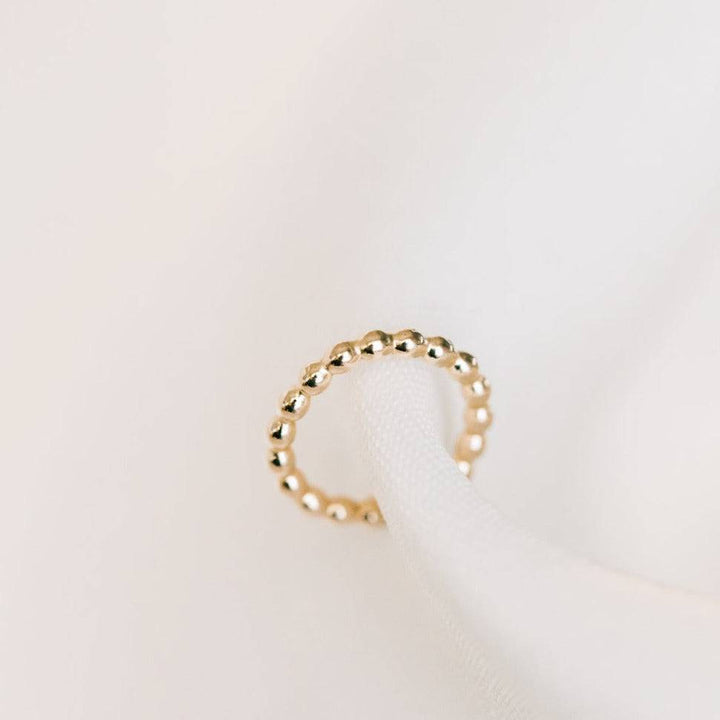 Beaded texture no-pierce ear cuff earring in 14k gold fill, offering a chic and hypoallergenic jewelry option.