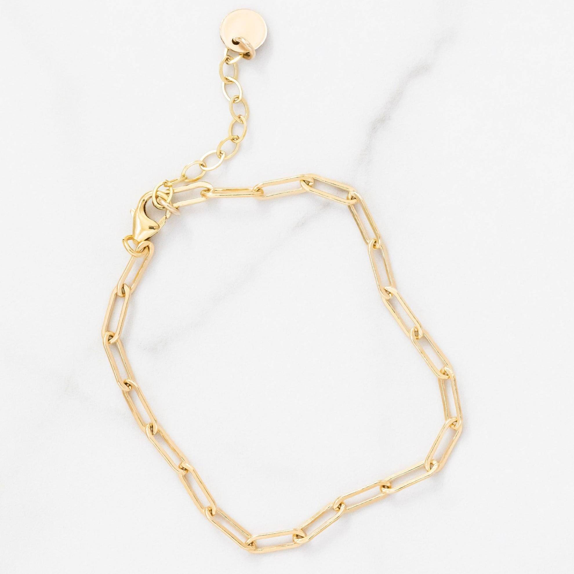 Layering Paperclip Chain Bracelet in 14k gold fill with adjustable clasp, perfect for everyday wear and stacking with other jewelry.