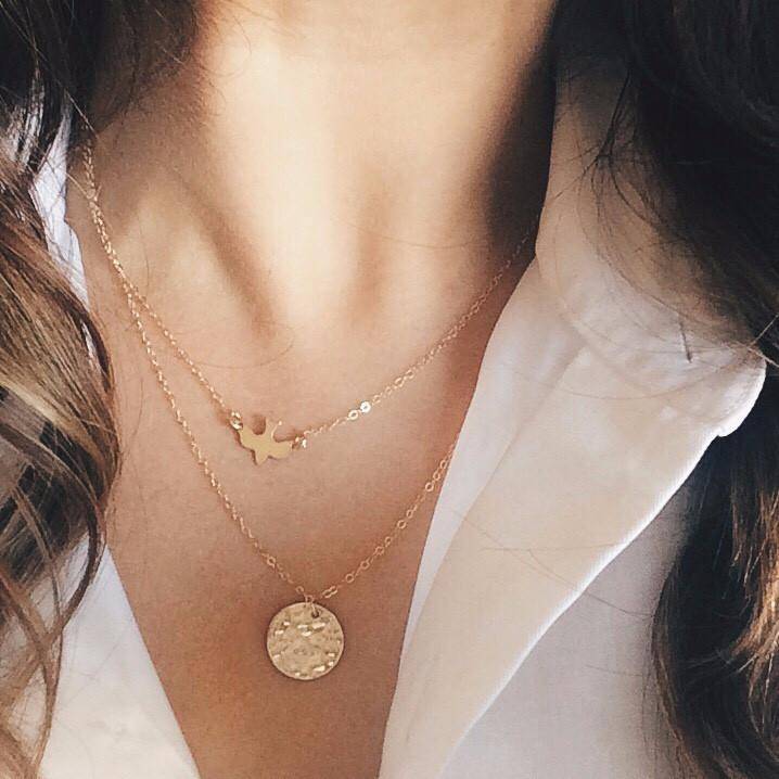 Layered look featuring the Soaring Bird Necklace paired with a textured gold pendant, ideal for stylish minimal jewelry layering.