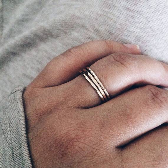 Thin Hammered Band Stacking Rings worn on hand, highlighting their dainty, stackable style perfect for casual or elegant outfits.