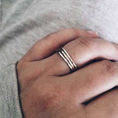 Thin Hammered Band Stacking Rings worn on hand, highlighting their dainty, stackable style perfect for casual or elegant outfits.